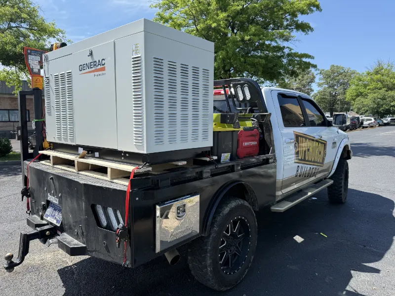 A generator is being delivered on Upchurch Builders truck for installation.