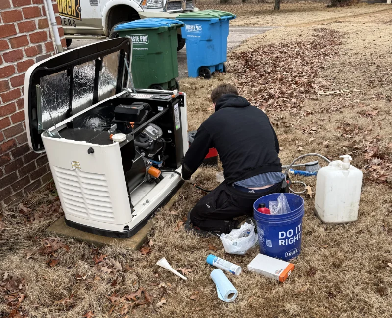 A technician is servicing a whole home generator from Generac.