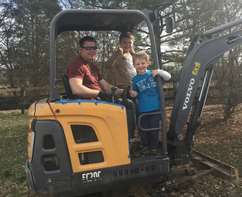 Lee and the boys at the job site clearing dirt.