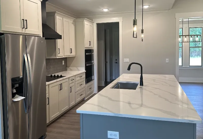 A modern kitchen with quartz countertops.