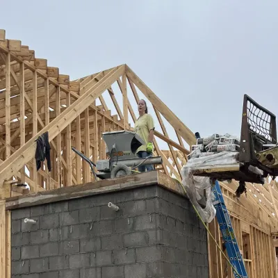 Storm shelter concrete pour with wood framing in the background.