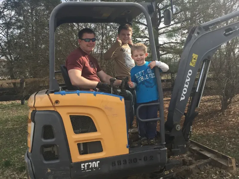 Lee and the boys at the job site clearing dirt.